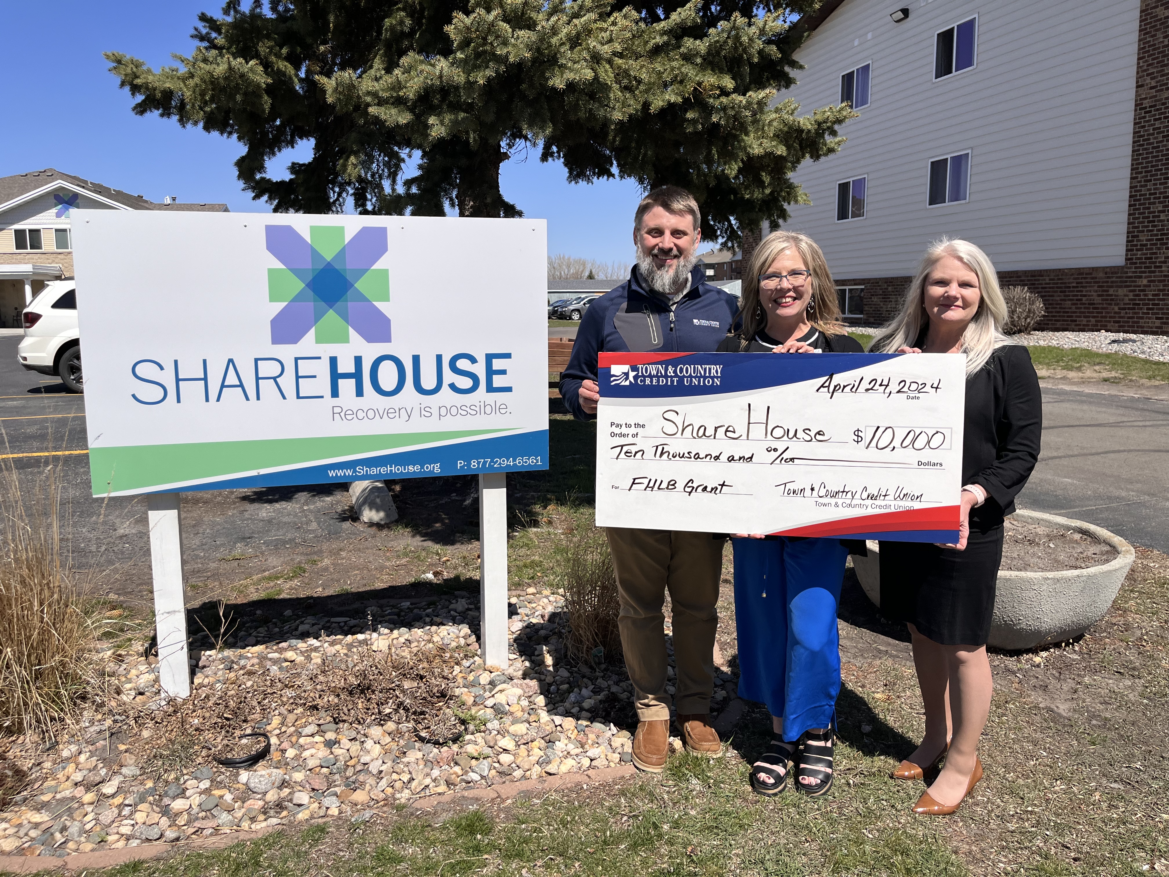 Photo of Town & Country and ShareHouse Representatives holding a large check for $10,000 presented to ShareHouse for a FHLB Grant