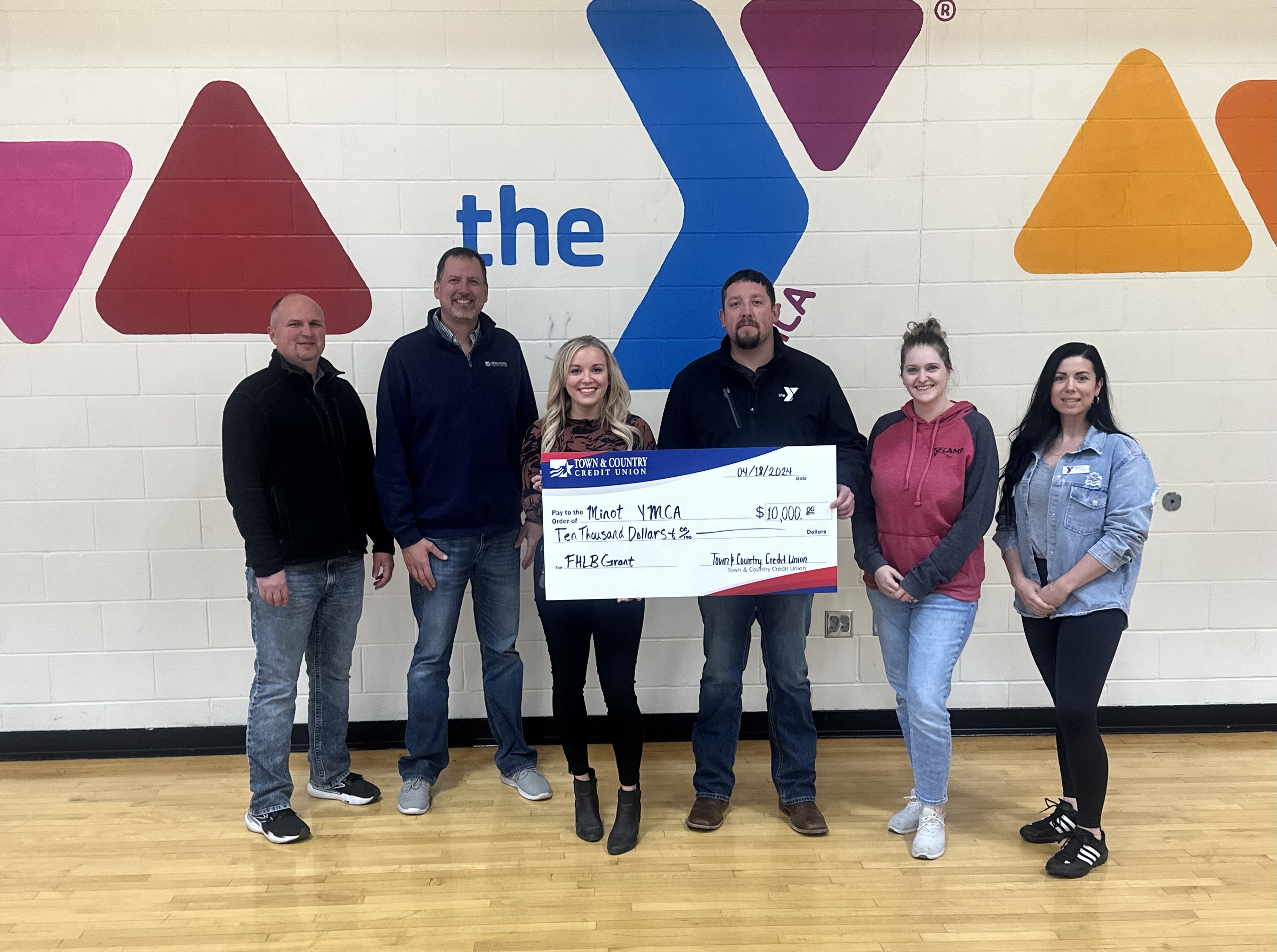 Photo of Town & Country and The Minot YMCA Representatives holding a large check for $10,000 presented to the YMCA for a FHLB Grant
