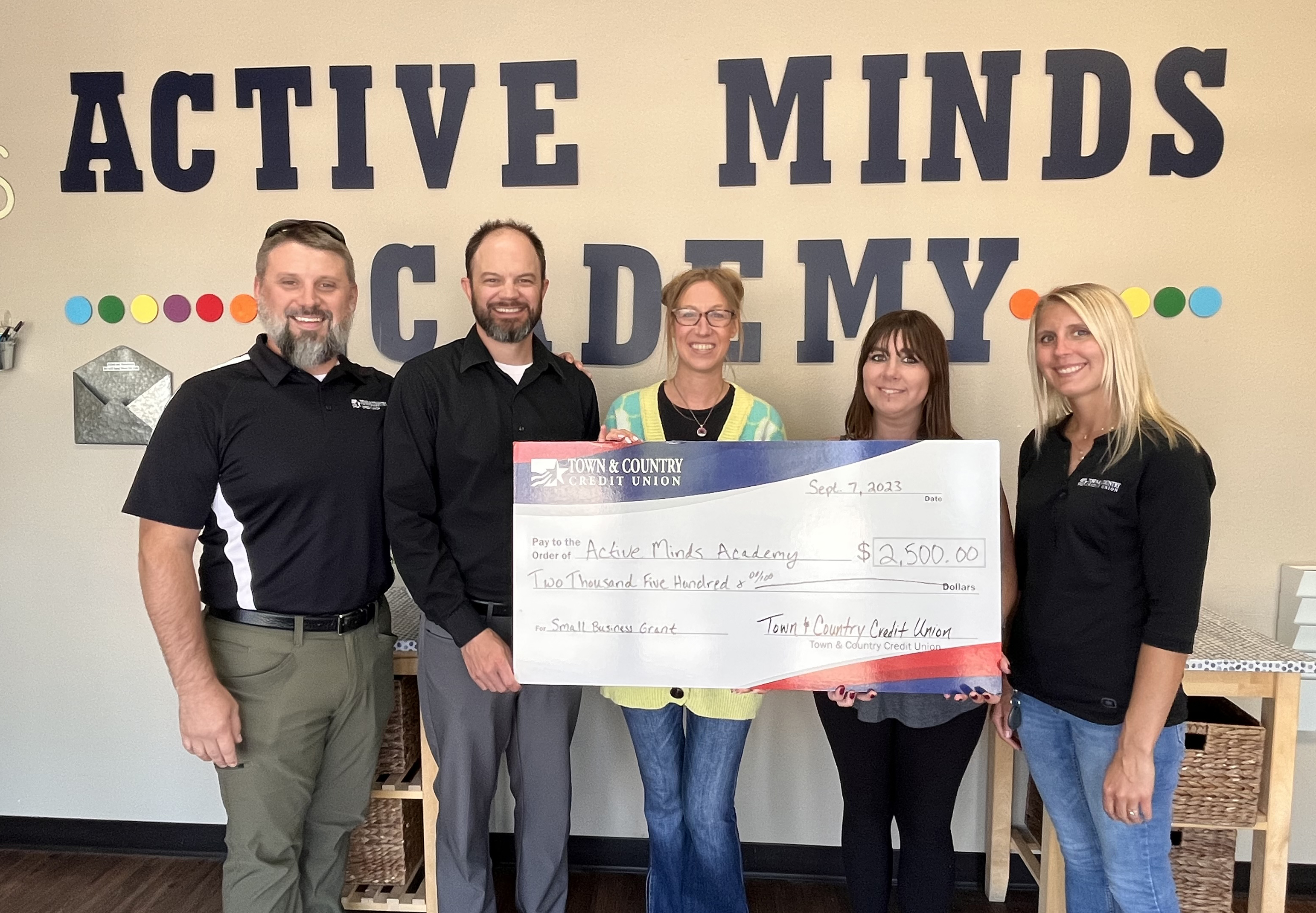 Town & Country Credit Union presenting a ceremonial check to Active Minds staff