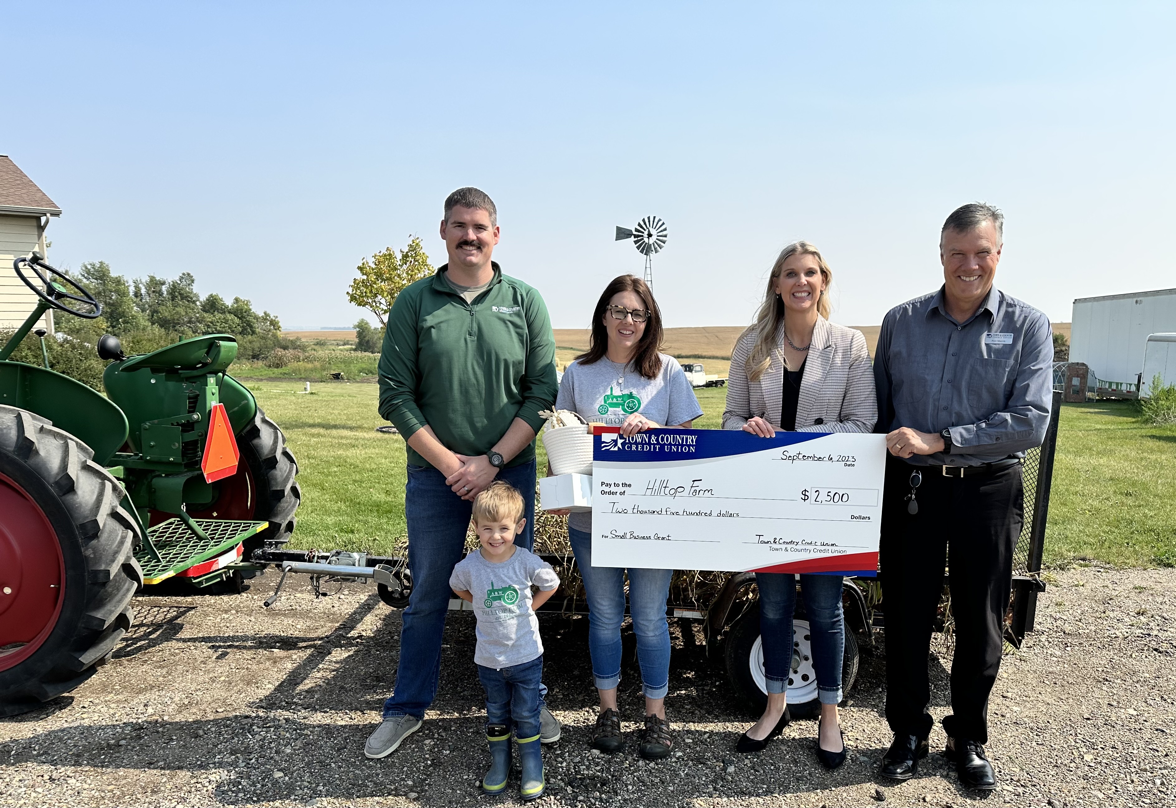 Hilltop Farm accepting a donation check.